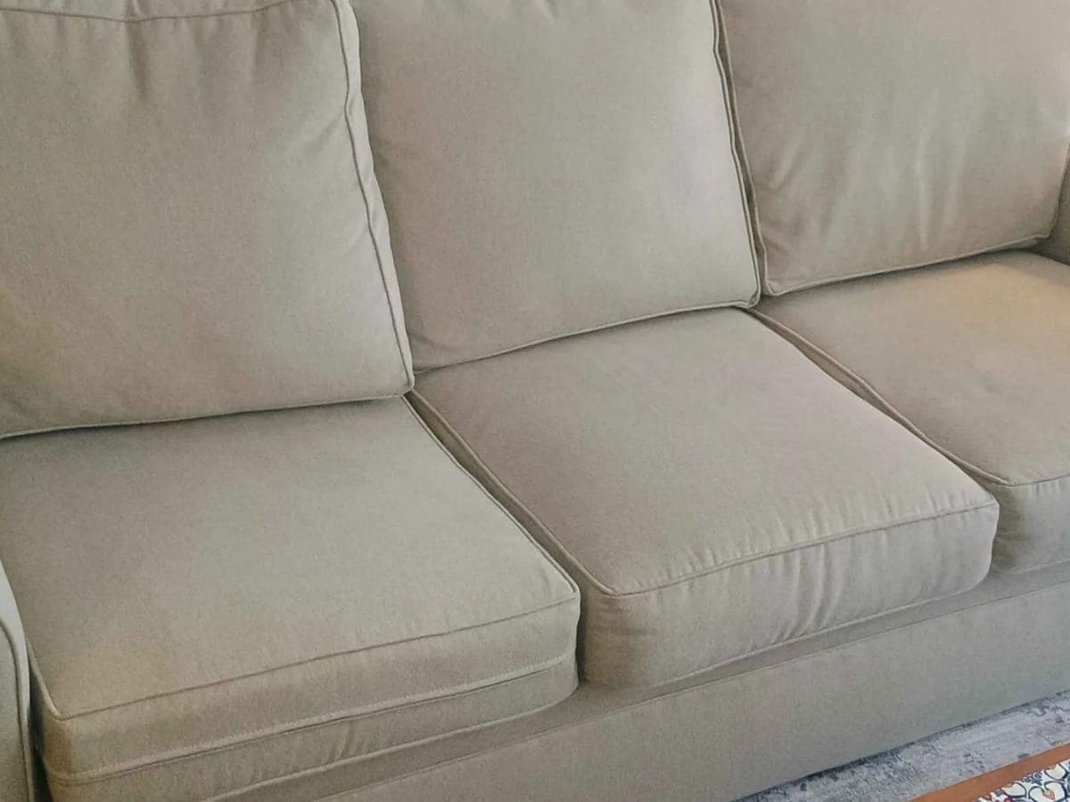 Sage green three cushion sofa after in home cleaning, the fabric even from arm to arm